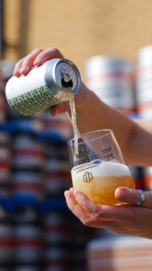 Person pouring can of Tamarind & Lime Leaf Sour