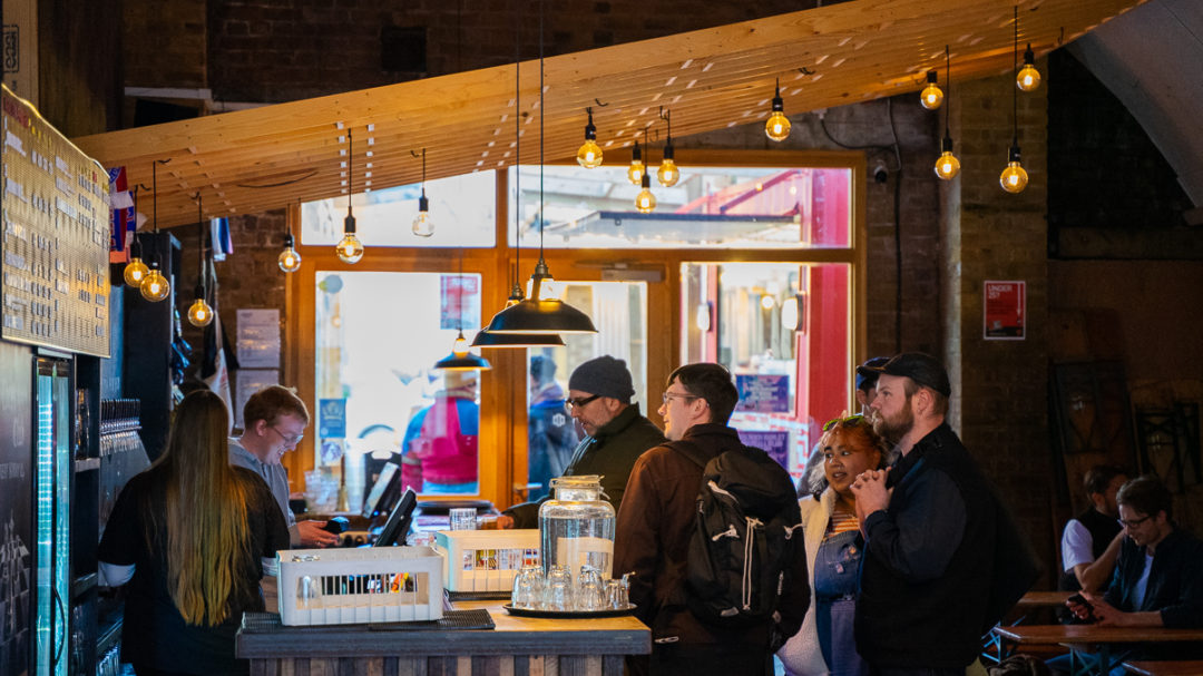 People queuing at the bar in Brick Brewery Taproom