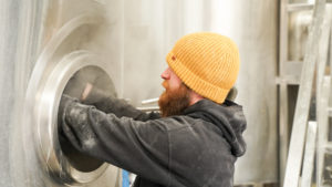 Brewer Jamie adding hops to a brew